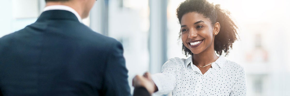 woman shaking hands with man