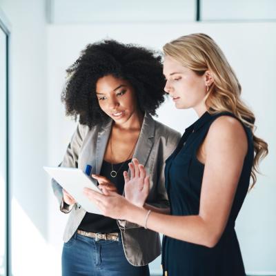 women-in-house-looking-at-tablet